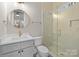 Bright bathroom with a glass shower and round mirror over a single vanity at 3945 Ostler Ct, Lancaster, SC 29720