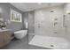 A modern bathroom showcases a soaking tub and glass enclosed shower, providing luxury at 3945 Ostler Ct, Lancaster, SC 29720