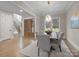 Dining room with modern chandelier, hardwood floors, and view of the foyer at 3945 Ostler Ct, Lancaster, SC 29720