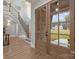 Bright foyer featuring a staircase with iron railings and beautiful hardwood floors at 3945 Ostler Ct, Lancaster, SC 29720