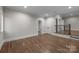 Finished living room with hardwood floors and neutral walls with access to additional rooms at 3945 Ostler Ct, Lancaster, SC 29720