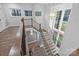 Elegant staircase featuring wood and iron railings and a large chandelier and ample windows at 3945 Ostler Ct, Lancaster, SC 29720