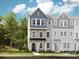 3-story townhome with blue and beige exterior, and 2-car garage at 4096 Skyboat Cir, Fort Mill, SC 29715