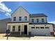 Modern two-story home with white siding, black roof, and an attached two-car garage at 4122 Eastover Glen Rd # 0316, Charlotte, NC 28269