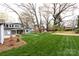 Landscaped backyard with large lawn, patio, and mature trees at 423 W Bell St, Statesville, NC 28677