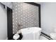 Modern bathroom featuring a freestanding bathtub and geometric tile at 423 W Bell St, Statesville, NC 28677