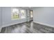 Charming bedroom with grey wood flooring and large windows at 423 W Bell St, Statesville, NC 28677