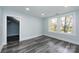 Bright bedroom with grey wood flooring and ample natural light at 423 W Bell St, Statesville, NC 28677