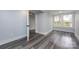 Bright bedroom featuring grey wood-look floors and large windows at 423 W Bell St, Statesville, NC 28677