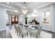 Elegant dining room with glass table, chandelier, and hardwood floors at 423 W Bell St, Statesville, NC 28677