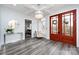 Spacious entryway with hardwood floors, a statement chandelier, and double doors at 423 W Bell St, Statesville, NC 28677