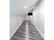 Long hallway with grey wood flooring and sloped ceiling at 423 W Bell St, Statesville, NC 28677