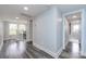 Light and airy hallway with grey wood flooring at 423 W Bell St, Statesville, NC 28677