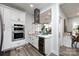 White kitchen with double oven, wine cooler, and marble countertops at 423 W Bell St, Statesville, NC 28677