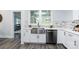 Modern kitchen with farmhouse sink, stainless steel appliances, and white cabinets at 423 W Bell St, Statesville, NC 28677