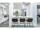 Modern kitchen island with seating, stainless steel appliances, and white cabinets at 423 W Bell St, Statesville, NC 28677