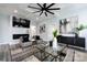 Modern living room with fireplace, hardwood floors, and ceiling fan at 423 W Bell St, Statesville, NC 28677