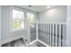 Upper hallway with a view and an elegant staircase at 423 W Bell St, Statesville, NC 28677