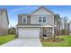 Two-story house with gray siding, white garage door, and landscaping at 4445 Dusty Orchard Rd, Kannapolis, NC 28081