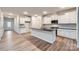 Kitchen with white cabinets, granite countertop island, and hardwood floors at 4445 Dusty Orchard Rd, Kannapolis, NC 28081