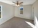 Bright bedroom with carpeted floor, ceiling fan, and large windows at 4683 Falcon Chase Sw Dr, Concord, NC 28027