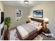 Virtually staged bedroom with a wooden bed frame and neutral decor at 4683 Falcon Chase Sw Dr, Concord, NC 28027