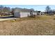 Home's exterior showcasing garage and backyard deck at 4683 Falcon Chase Sw Dr, Concord, NC 28027