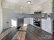 Kitchen with white cabinets, stainless steel appliances, and vinyl flooring at 4683 Falcon Chase Sw Dr, Concord, NC 28027