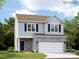 Two-story house with blue siding, stone accents, and a two-car garage at 5725 Olive Beach Rd, Kannapolis, NC 28081