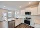 Contemporary kitchen with stainless appliances, white cabinets, and granite countertops at 5725 Olive Beach Rd, Kannapolis, NC 28081