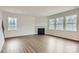 Living room with wood floors, fireplace, and multiple bright windows at 5725 Olive Beach Rd, Kannapolis, NC 28081