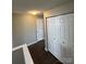 Hallway with wood-look flooring, closet and white doors in a home featuring neutral paint at 5956 Prescott Ct, Charlotte, NC 28269