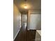 Hallway with wood-look flooring and neutral paint leads to a bedroom or living room at 5956 Prescott Ct, Charlotte, NC 28269