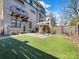 Private backyard with patio, artificial turf, and wood fence at 633 Mattie Rose Ln, Charlotte, NC 28204