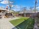 Private backyard with patio, artificial turf, and wood fence at 633 Mattie Rose Ln, Charlotte, NC 28204