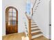 Elegant entryway with arched wood door and hardwood floors at 633 Mattie Rose Ln, Charlotte, NC 28204