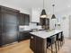 Modern kitchen features dark cabinetry, a large island, and stainless steel appliances at 633 Mattie Rose Ln, Charlotte, NC 28204