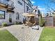 Brick paved patio with seating area, umbrella, and artificial turf at 633 Mattie Rose Ln, Charlotte, NC 28204