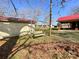 Backyard with a swing and outbuildings, providing ample outdoor space and storage at 6523 Prospect Rd, Monroe, NC 28112