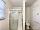 This bathroom features a glass shower with a sliding door and white toilet at 6523 Prospect Rd, Monroe, NC 28112