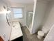 This bathroom features a single sink, framed mirror, shower, and toilet at 6523 Prospect Rd, Monroe, NC 28112