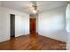 Bedroom featuring hardwood floors, ample closet space, and a ceiling fan for added comfort at 6523 Prospect Rd, Monroe, NC 28112