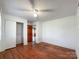 A bedroom featuring hardwood floors, a closet, and base trim molding at 6523 Prospect Rd, Monroe, NC 28112