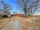 Exterior shot of a brick house with a red roof, long driveway and a rural mailbox at 6523 Prospect Rd, Monroe, NC 28112