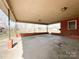 This covered patio has brick pillars and a concrete floor at 6523 Prospect Rd, Monroe, NC 28112