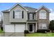 Two-story house with gray siding, stone accents, and a two-car garage at 675 Winding Branch Rd, Rock Hill, SC 29732