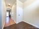 Hardwood floor hallway with coat closet and access to kitchen at 7562 Silver Arrow Dr, Charlotte, NC 28273