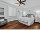 Bright bedroom with hardwood floors, plantation shutters and a comfortable bed at 7672 Nautical Vw, Denver, NC 28037