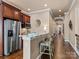 Kitchen breakfast bar with stainless steel appliances and granite countertops at 7672 Nautical Vw, Denver, NC 28037