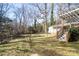 Spacious backyard with mature trees and a wooden deck at 7716 Elwood Dr, Charlotte, NC 28227